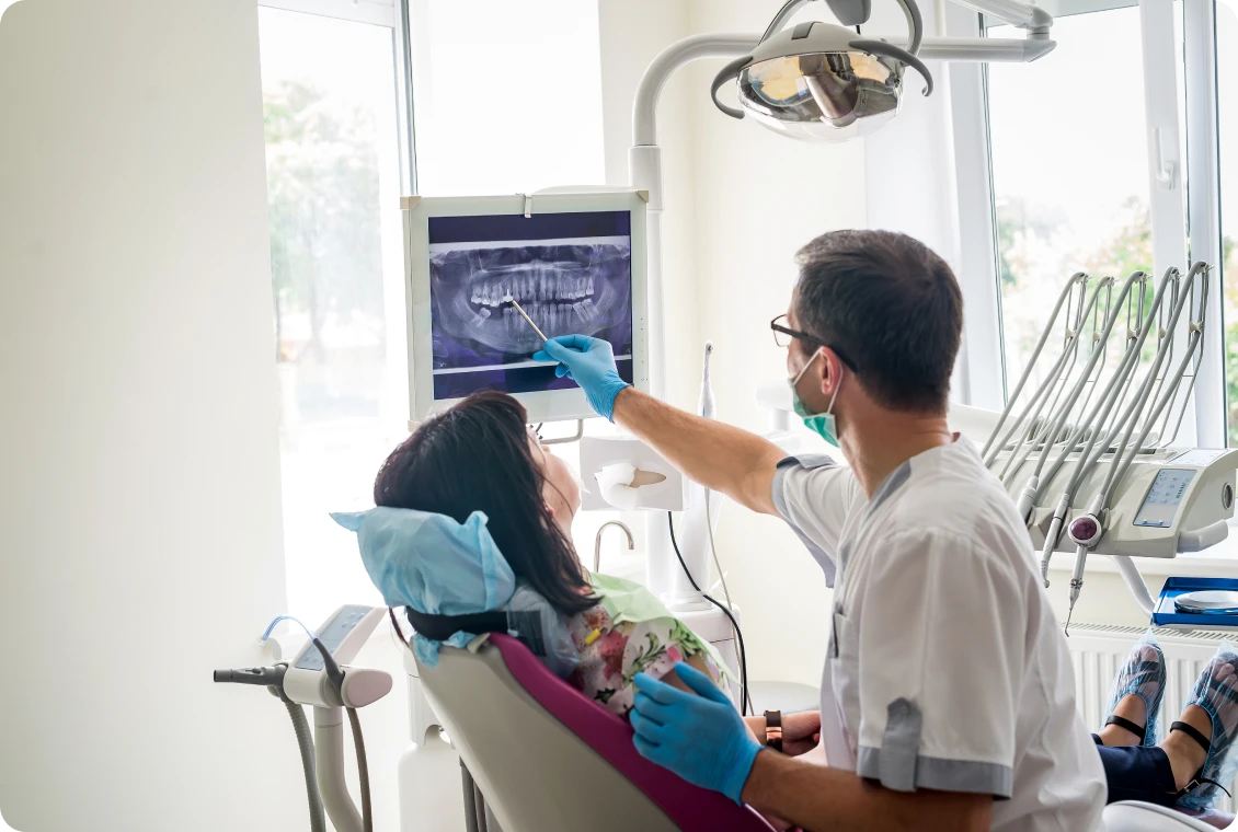 Dentist showing patient an X-ray image.